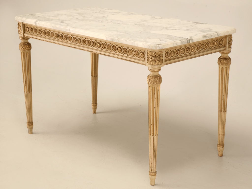 Superb example of old-world craftsmanship at its absolute finest. Intricate hand-carved details highlighted with spectacular original paint married with it's original Italian marble top make this fine table a true knockout. The perfect table to be