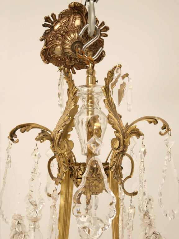 Glamorous vintage French Baroque chandelier with an outstanding bronze colored frame and elegant hand-cut crystals, too. Opulent in every way imagineable, this chandelier would be awesome in any room of the home. This fine chandelier just arrived