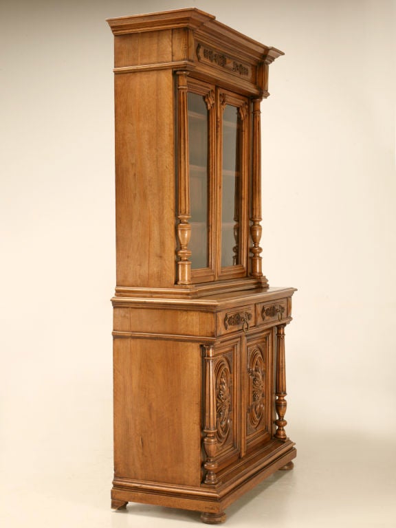 Interesting and unusual petite sized bookcase/cabinet that has a lot to offer within its shallow confines. Perfect in most any room of the home, this extraordinarily hand-carved walnut cabinet has as much charm and character as those much larger.