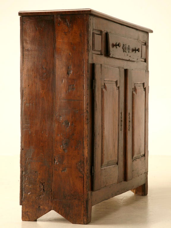 Outstanding use of figured cherrywood first draws your eye to this remarkable find. Having a fine patina and unmistakable charm, this gorgeous circa 1710 cupboard has a shallow footprint making itself a perfect candidate for so many places. This