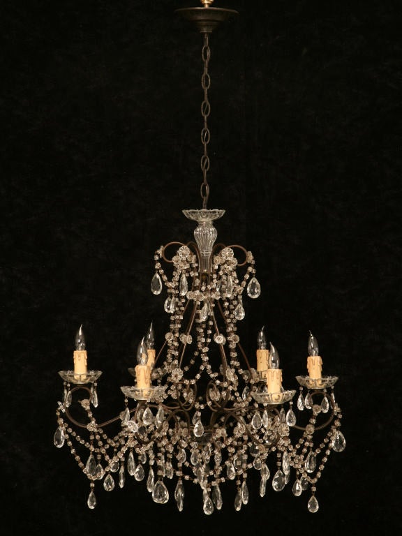 If you just so happen to be one of those people that appreciates the finer things in life, look no further as this is awesome. This fine original vintage Italian chandelier gleams with its faceted bead-work, numerous glass bobbles, and a classy gilt