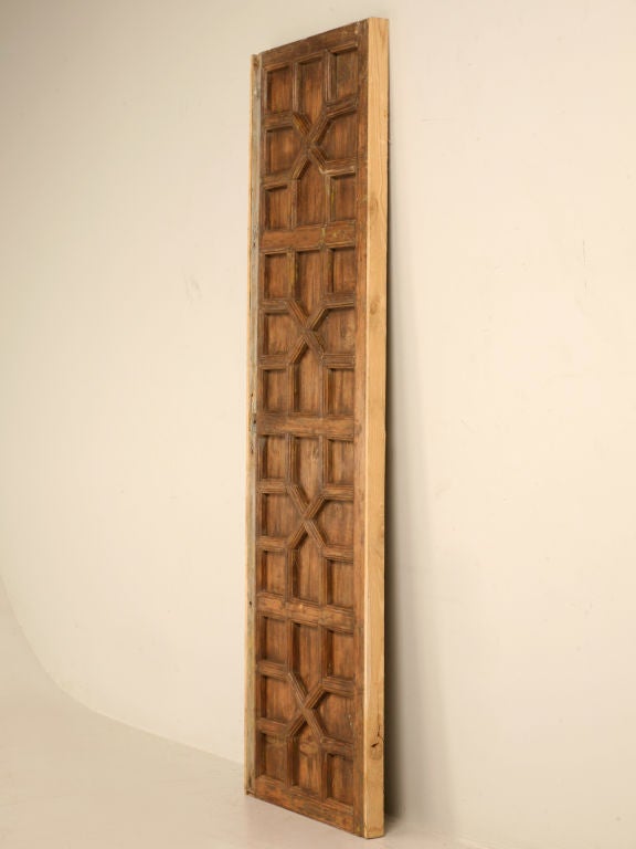 Outstanding antique Indonesian 4 panel door with a unique and interesting geometric design. This fine door would be awesome utilized as a pantry door in a newly built home, hiding the passageway to the basement wine cellar, or add a piece of glass