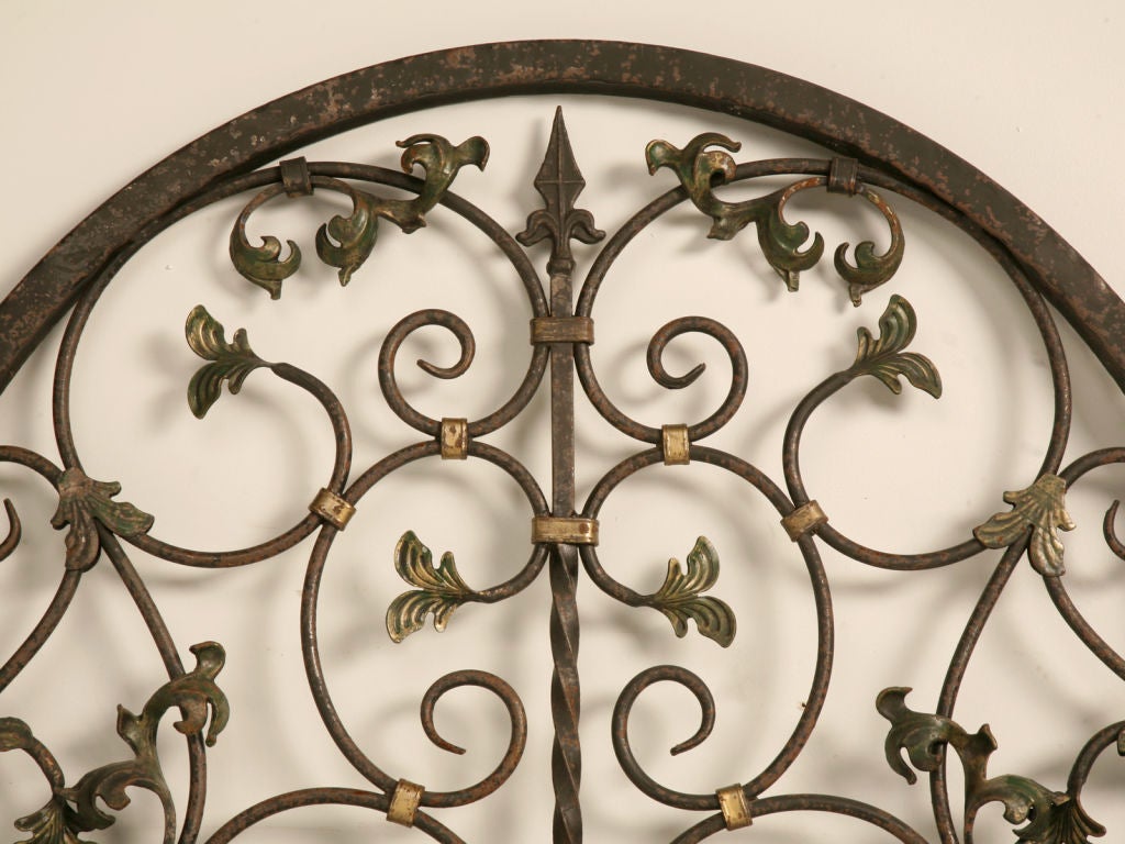 Magnificent pair of very ornate and decorative iron gates, or widow covers. These are absolutely stunning with their many scrolled details and floral motif. Perfect as garden gates welcoming visitors, built into a wall offering a protected glimpse