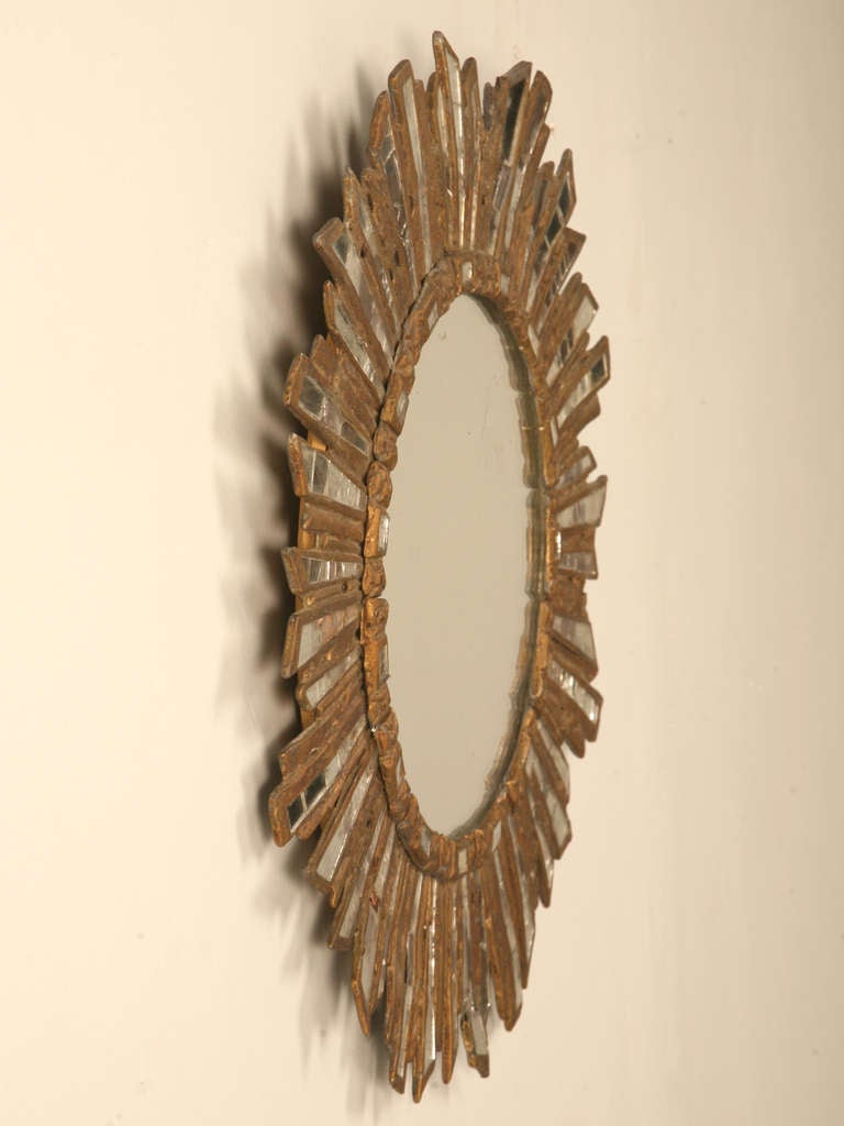 Amazing original un-restored 1920’s French early Art Deco sunburst mirror made with a multitude of individual hand-cut mirrors recessed into a unique cast lead frame. Words can't describe the beauty, or the radiance this exquisite mirror provides.
