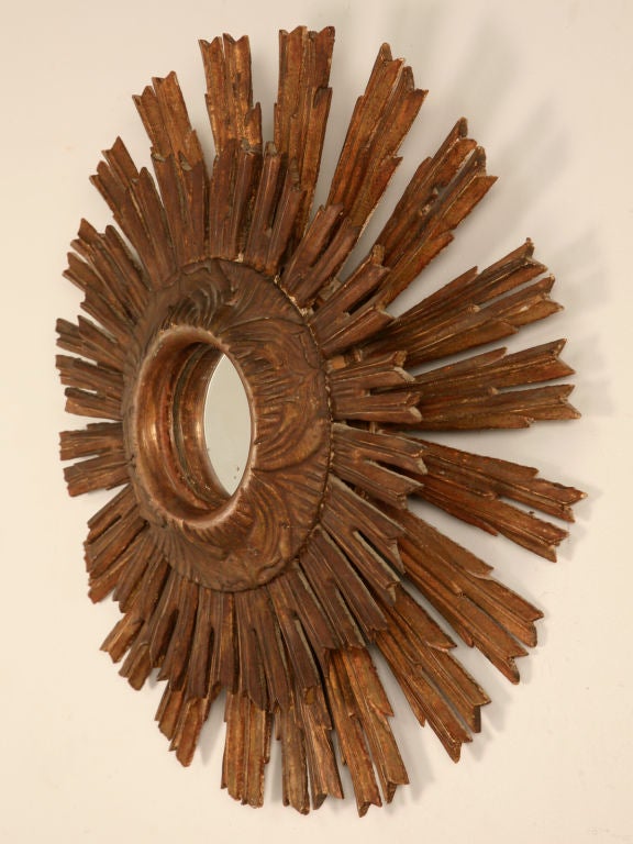 Unique and stunning, this Antique Italian Carved and Gilded Sunburst form Mirror has two layers of rays which add to it's visual interest. This fine Sunburst Mirror makes an incredible statement, our in-house designer usually showcases Sunburst