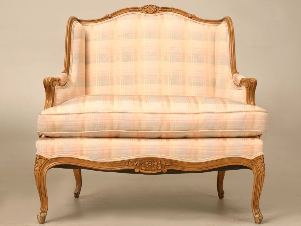 Incredible pair of vintage Baker Furniture Company’s French Louis XV styled wingbacked bergeres and ottoman with a fine fruitwood finish. This fine set offers all the characteristics you’d look for in a fine antique, though they offer the renowned