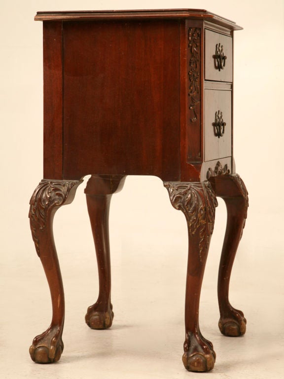 Well carved and decorated vintage American mahogany 2 drawer nightstand in the classic Chippendale style. All four legs are carved and decorated with early Chippendale influences as are the front canted corners giving this finely constructed