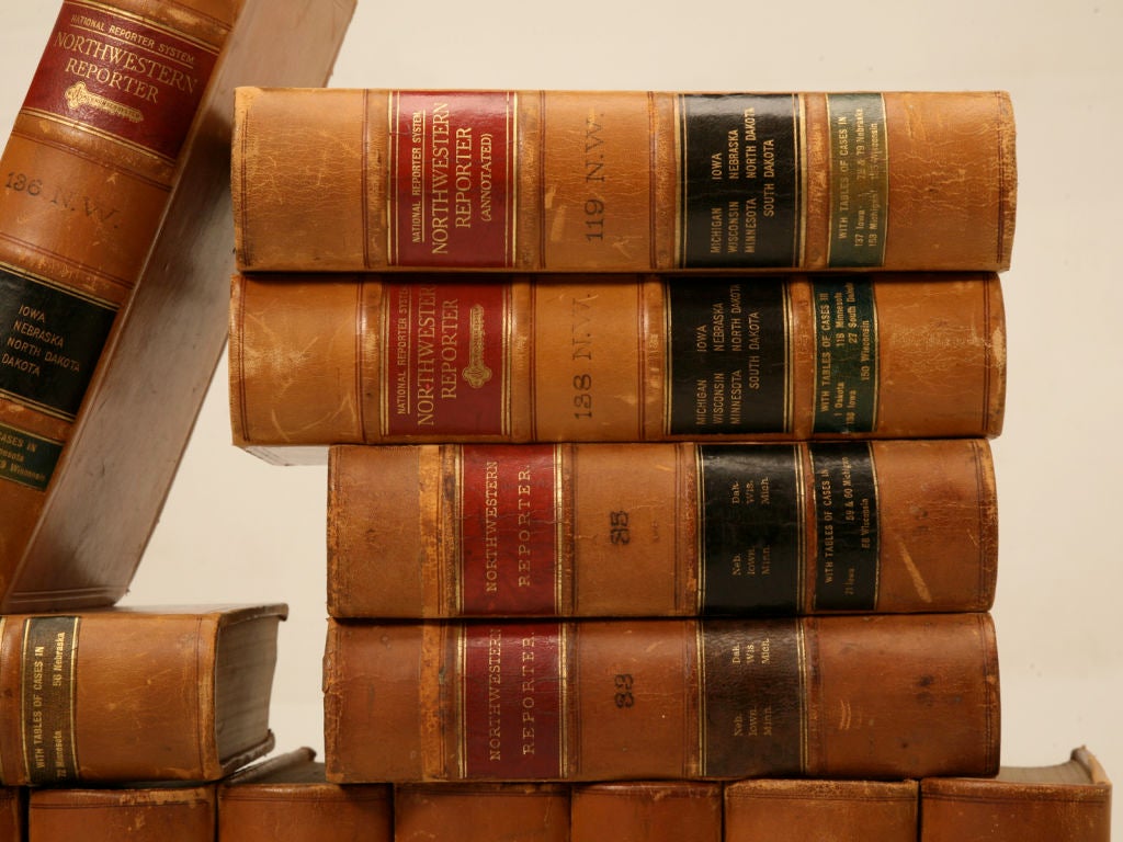 Gorgeous set of 28 American original antique leather bound law books, that decorators and designers nationwide are obsessed with. The rich tan leather with their black and red accents are gorgeous utilized in bookcases throughout ones home or