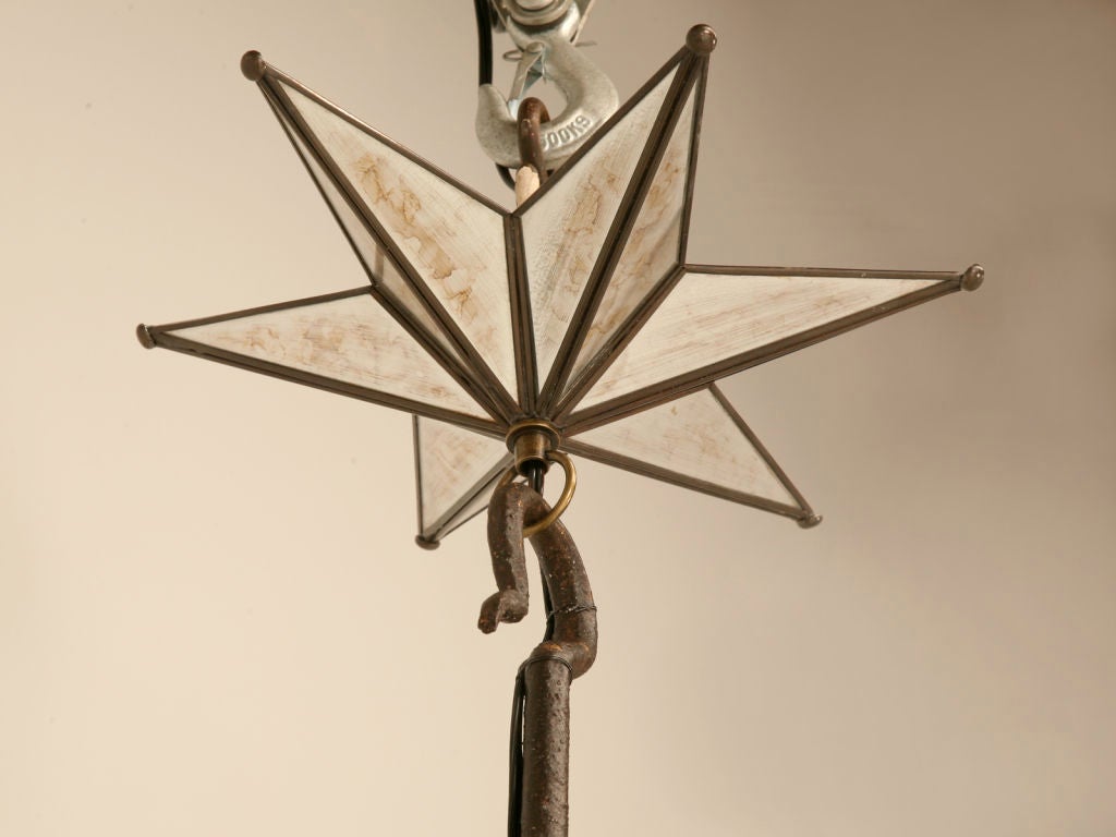 Fantastic original antique Spanish hand wrought iron seven light chandelier, that has been newly wired for electricity. Believe it or not, this showpiece was originally utilized as a hanging fixture for candles way back when. Thank goodness,