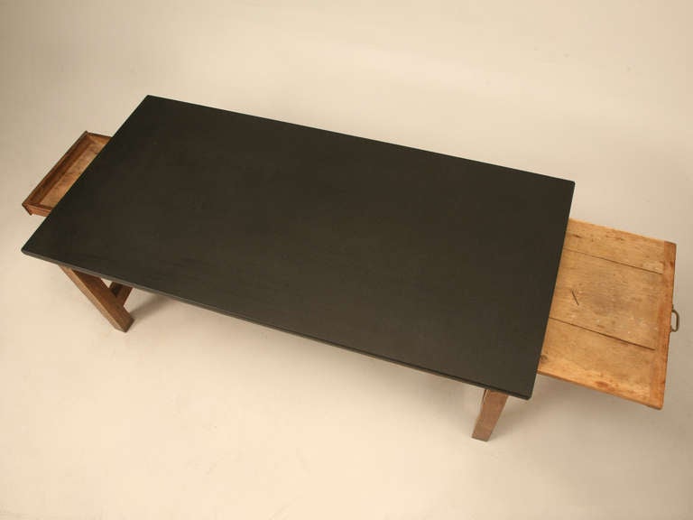 Early 19th century Provencal bakery table with a slate top resting upon a massive steel reinforced quarter-sawn oak base with exquisite joinery. One large drawer and one concealed bread board complete this spectacular offering. Ready to work, this