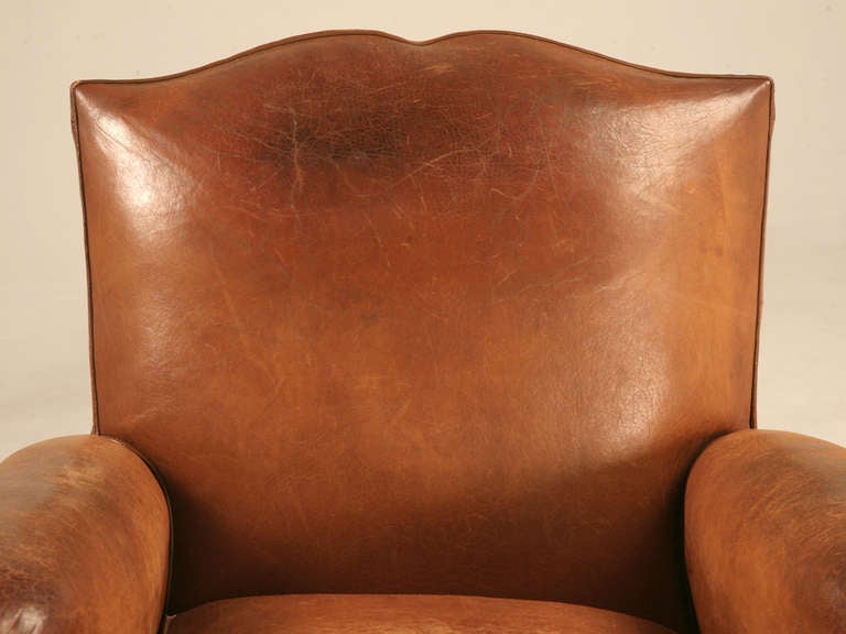 Incredible pair of original vintage French leather club chairs retaining their spectacular soft and supple original leather. Spot on with tons of character and charm, this pair offer the highly coveted moustache backs. You will be happy to know that