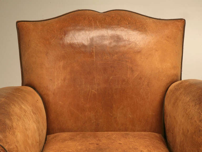 Incredible pair of original vintage French rugged and handsome moustache back leather club chairs. Oozing with masculinity, character and an unbelievable seductive attitude, these chairs are the ones most everyone wants. 

In 1925, the Paris