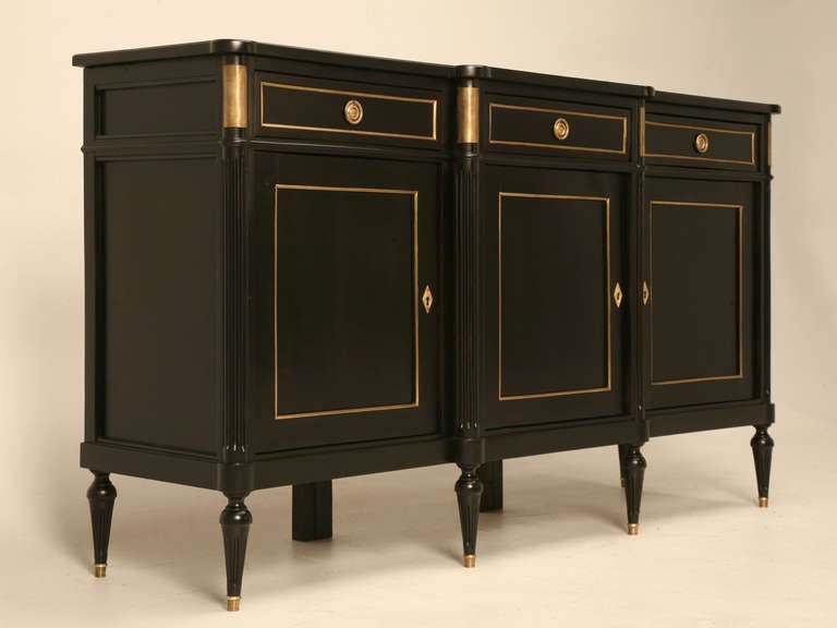 Circa 1930s French ebonized three door and three drawer Louis XVI style buffet, Our in house Old Plank restoration department restored the buffet both cosmetically and structurally. The ebonizing was applied in a manner to allow the natural tones of