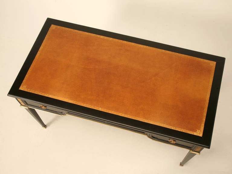 Circa 1930s French ebonized mahogany writing desk that we thoroughly restored by our in house restoration workshop. The desk was stripped to the bare mahogany and carefully stained layer upon layer of various tints so to allow the natural mahogany