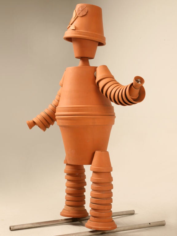 Outstanding vintage English terra-cotta flower pot man. This guy is the perfect folk art host for most anywhere, here at the store we have him in the foyer welcoming guests, though he could just as easily be utilized outdoors. Standing on a metal