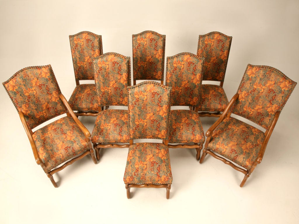 Extraordinary set of eight vintage French solid oak Louis XIII/Os de Mouton dining chairs retaining their awesome French tapestry upholstery, which is still in very good condition. This is a spectacular set! Most dining chairs from France require