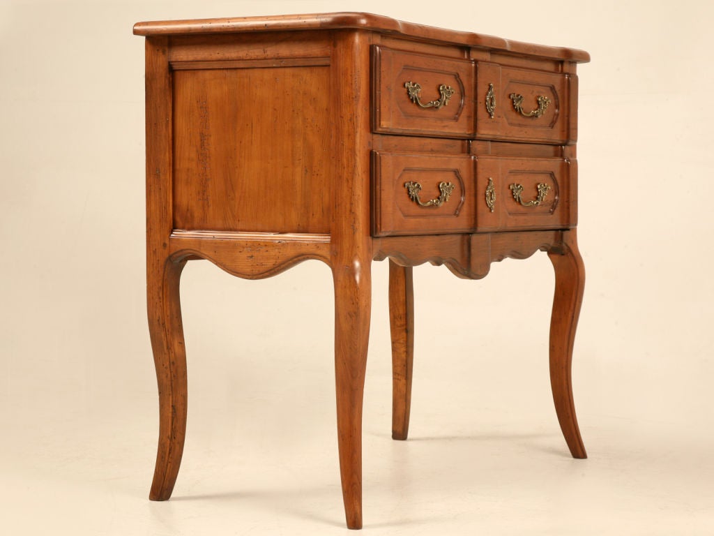 Ooo-wee! Endless possibilities with this striking vintage French cherry-wood 2 drawer commode. Perfect most anywhere, the style of this piece is both elegant and timeless. Use it in a powder room supporting a vessel sink bowl and needed toiletries