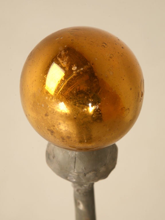 Stunning antique zinc finial once the crowning jewel on the top of a turret on a French château--still retaining its amber mercury glass with tiny bubbles tip. In the 18th century, zinc became a popular roofing material in Belgium and France.