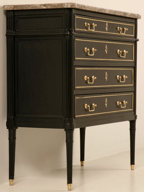 Truly amazing this petite antique French Louis XVI 4 drawer commode steals the show with its stunning finish, polished brasses, and original marble top. Although petite in size, this fine chest has oodles of charm and personality the size of a