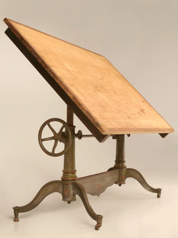 Dietzgen Drawing Tables are made of cast iron with rigid and durable construction and are nicely japanned. The top is raised and lowered by rack and pinion and can be tilted and clamped at any angle desired. The top consists of a regular pinewood