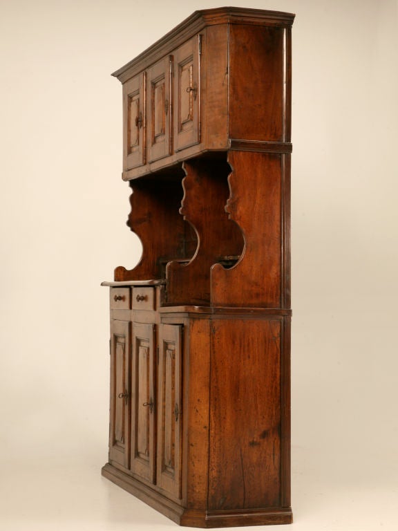 18th century French solid walnut cupboard, buffet, or dry bar. Showcasing excellent old world craftsmanship, this striking cupboard offers six locking cupboards and seven drawers within a relatively small footprint. Hand dove-tailed drawers,