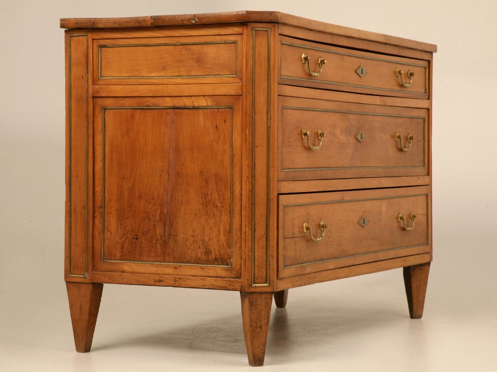 Outstanding original antique French Directoire style commode constructed of solid cherrywood with an amazing sun-bleached, book-matched, figured walnut two board top. Superior old-world craftsmanship is showcased in this breathtaking example, the