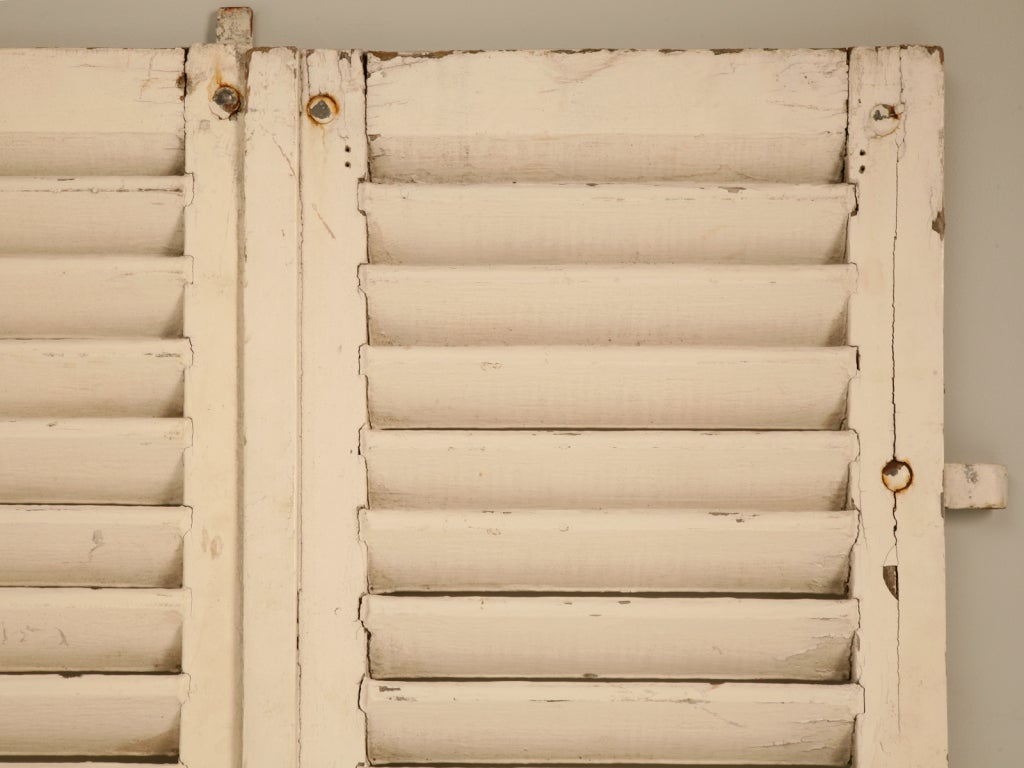 Retaining time-worn white paint and their original hardware, these incredible antique French plantation style shutters are ready to add extra style and pizazz to your home. Whether they are utilized over an existing window to shade Mother Nature's