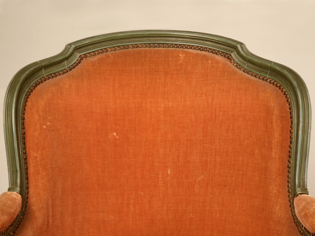 Distinctive antique French Louis XV style bergère pumpkin chair, its distinctive orange mohair upholstery and green trim gave it this nickname. Ready for a relaxing afternoon of reading a good book and sipping your favorite beverage. We have had
