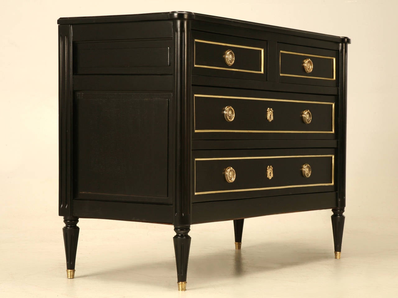 French Louis XVI ebonized commode with brass trim and hardware. Whomever made this commode and it certainly was in the 1900s, used the same techniques as craftsmen from the late 1700s. Take notice of the hand-cut dove-tailed drawers, which are