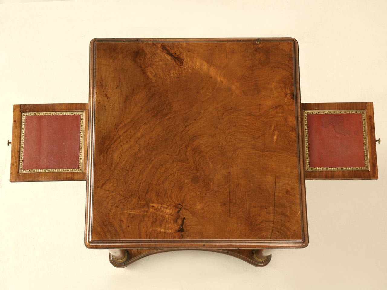 Elegant antique Empire style end table in an ever so slightly sun bleached walnut, which produced the warmest brown tones I have ever seen. The tabletop is one piece of wood and has been French polished to a high gloss, but we did not disturb the