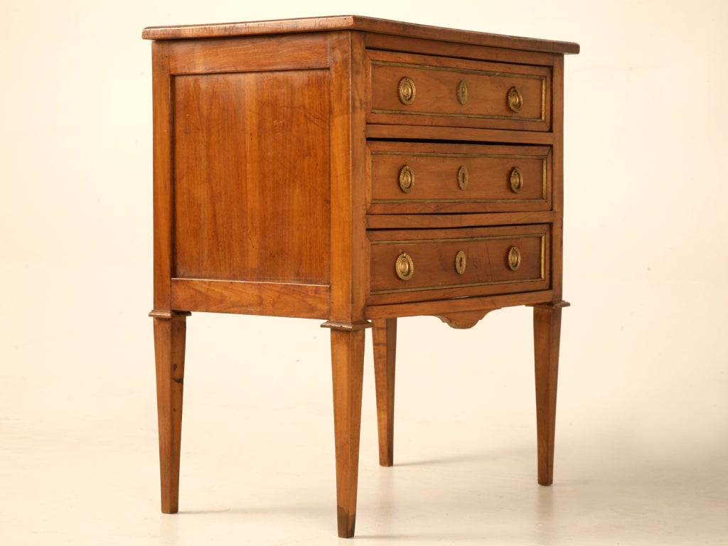 Spectacular original 18th century French Louis XVI 3 drawer bedside commode. This striking commode is expertly constructed of solid cherry, and retains its original brasses, too. Perfect as a nightstand in the master bedroom, as a fine hall chest in