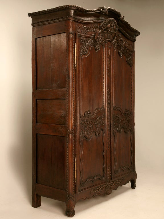 Phenomenal hand-carved 18th century solid oak wedding armoire from the Normandy region of France. Antique wedding armoires like this one, were hand-carved by a daughter's father, given  at a young age and filled with linens and clothes (a trousseau)