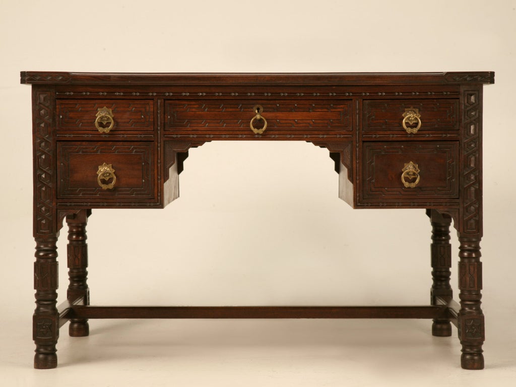 Unbelievable hand carved antique Spanish Revival desk and chair set. Outstanding attention to detail is realized as soon as your eyes see these phenomenal specimens of old-world craftsmanship at its absolute finest. Intricate hand carved details