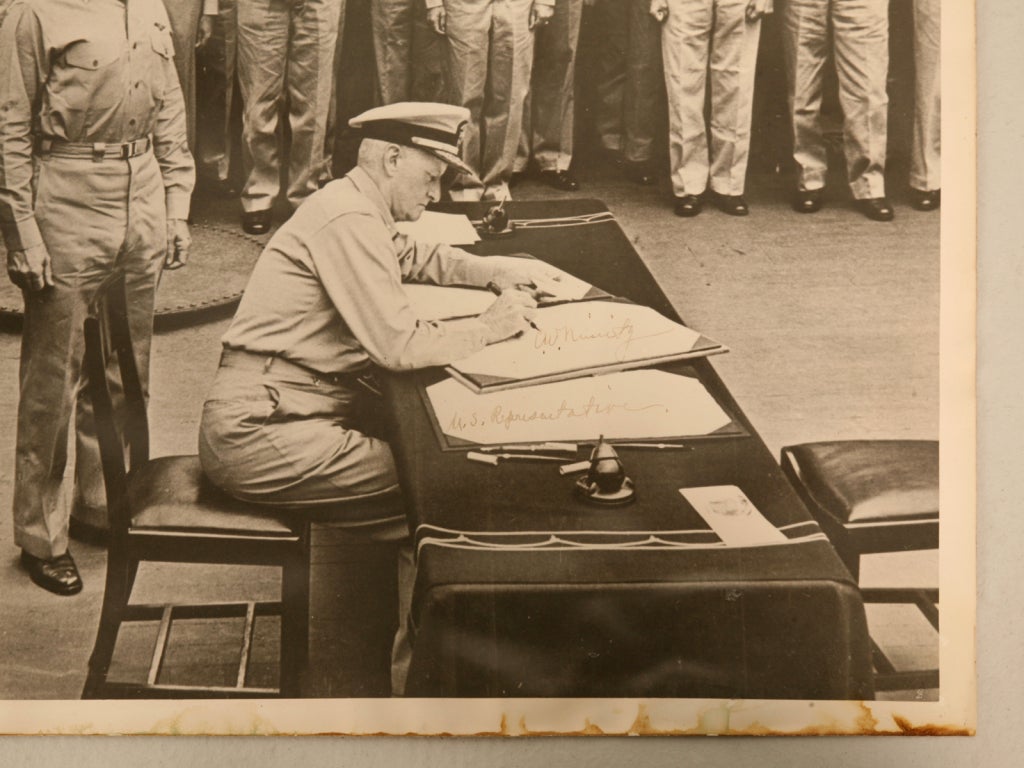 The autographed surrender photograph above shows Admiral C.W. Nimitz signing the copy of the Instrument of Surrender document aboard the U.S.S. Missouri; in Tokyo's Bay, Sept. 2, 1945. Nimitz was a Representative of the USA. At this precise moment