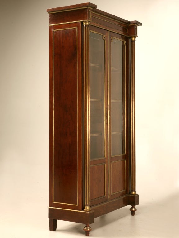 The piece d' resistance. Spectacular original antique French mahogany double door bibliotheque (bookcase) or china cabinet. With its original brasses intact, we gave them a light polish to further compliment this extravagant beauty. This is in fact