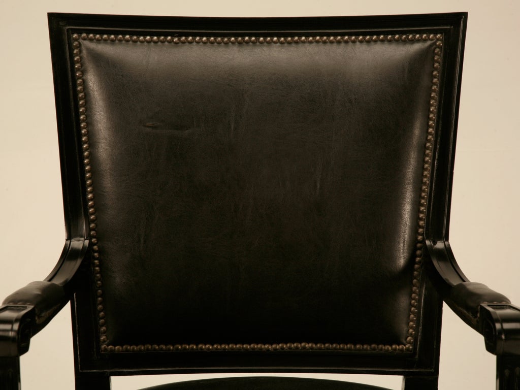 Absolutely incredible ebonized vintage French Louis XVI style armchair (fauteuil) with its original polished brasses. This gorgeous chair screams with character, the ebonized finish sharply contrasting with the polished brasses. Black leather