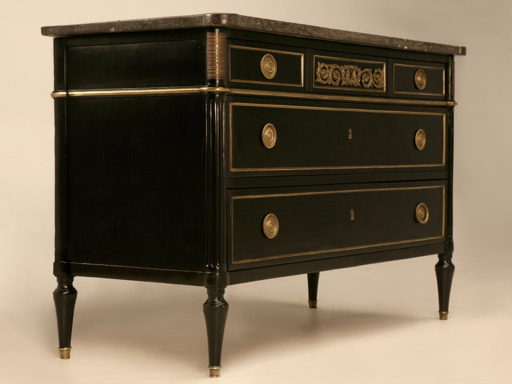 Breathtaking ebonized antique French 3 hand-dovetailed drawer commode with a striking, rich and sassy black finish, original polished brass hardware and trimmings, while retaining it's original marble top, too. This exquisite chest of drawers would