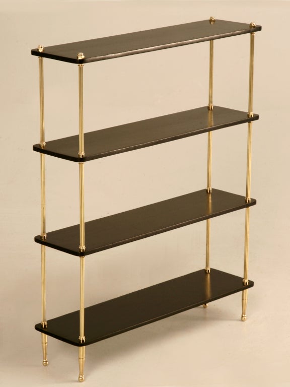 Outstanding petite French 40's polished brass and ebonized mahogany shelves. This is a real treasure, the way the deep black ebony shelves contrast with the original polished brasses; plus there are a million ways to utilize these fine shelves. Free