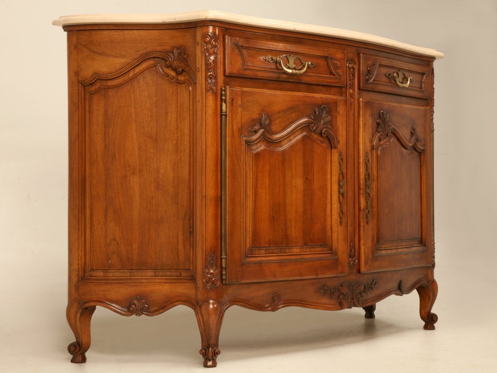 Outstanding vintage Italian 2 drawers over 2 door buffet with its original limestone top. This serpentine shaped buffet is expertly constructed of exotic solid figured walnut. Built to last a lifetime this Italian buffet also offers a plethora of