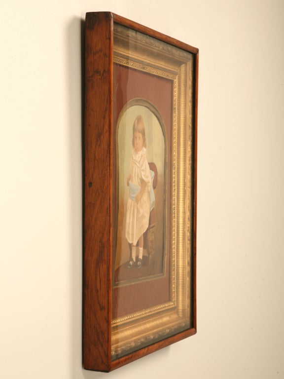 With a distinct hand, the painter has affectionately captured this child's delicate spirit. Highly detailed and of the utmost of skill, this painter showcases his/her abilities quite well. Framed in its original frame with gilded accents and