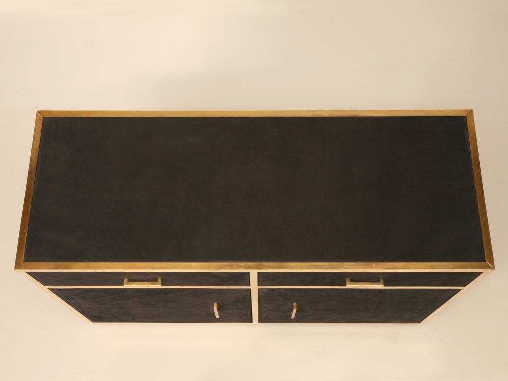 Ultra cool and sassy vintage French 1960's modern suede and brass 2 drawer over 2 door buffet. Simple clean lines accented with solid brass give this server plenty of attitude while the black suede softens it just a bit. Perfect in any room of the
