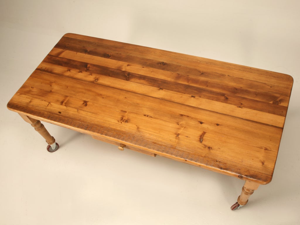 With a slight rustic feel, this solid pine table was constructed by hand in jolly old England. Set on casters, this fine table could be easily used a multitude of ways. Utilized as an island/work table in a country kitchen, a cool homework table in