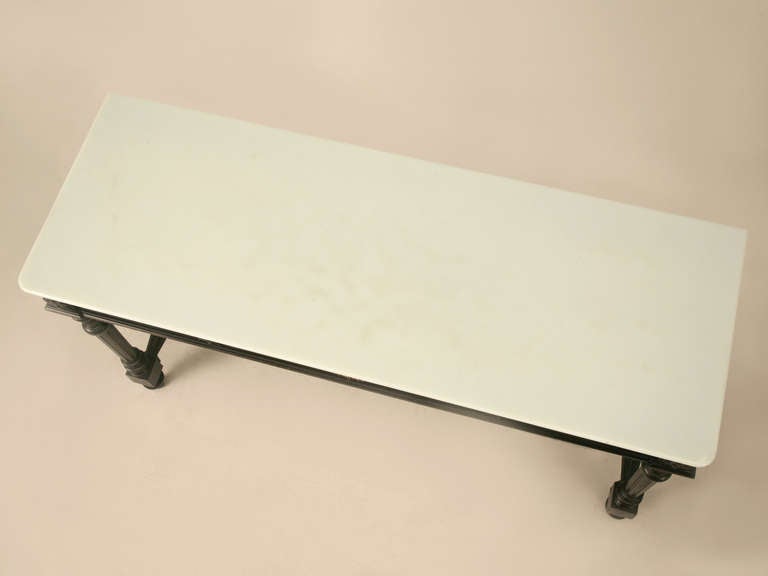 Fashioned in a timeless Louis XVI style, this table retains both its original ebonized finish and its icy blue/green opaline glass top (it looks white at first glance). A true masterpiece, this table offers a nifty and useful drawer for anything