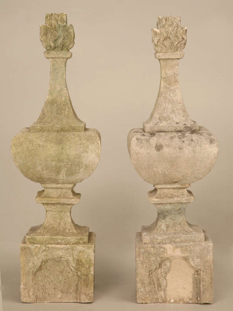 Incredible pair of original early 19th century hand-cut stone finials. Originally decorated a fence, rooftop or turrets, this exquisite pair of finials offer a unique and enthralling flame effect on the top tips. Not perfect specimens but,to have