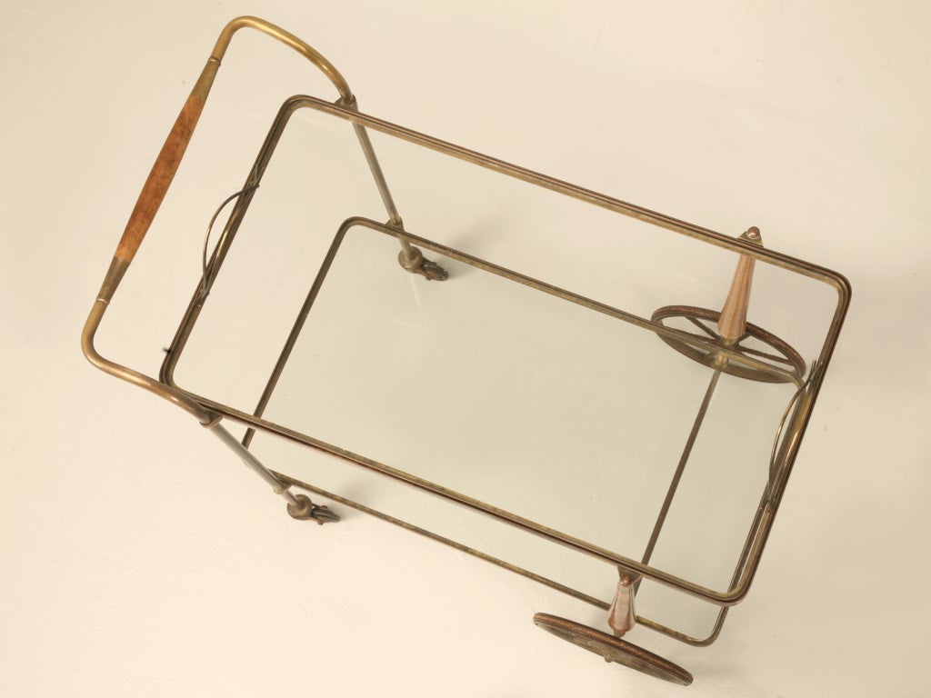 Fabulous French 1940s! This is one spectacular tea cart or trolley. Exquisitely crafted from wood, brass and glass, this fine cart also offers a removable hostess tray up top. Far exceeding the standards, this cart offers plenty of charm, character