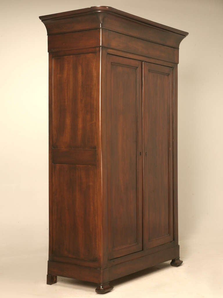 Absolutely breathtaking original antique French Louis Philippe armoire. This exquisite example showcases clean uninterrupted lines, a solid cherry wood construction and a stellar fitted interior to boot. Nice details abound in this magnificent