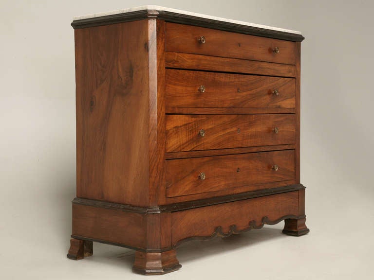 Original antique French Louis Philippe Commode or Chest of Drawers in beautiful figured Walnut with Ebonized accents and its original fitted Marble top, Providing good storage within its (4+1) four hand-dovetailed drawers, plus there's a hidden