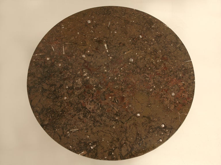 A clean, modern, and  minimalistic stainless steel base offers a stark contrast to this exotic, drop dead gorgeous cut of fine Moroccan fossilized stone. Showcasing several shades and colors, this sophisticated stone will have you wanting for more.