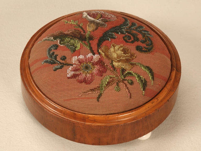 Hand beaded, mahogany framed Victorian ladies tuffet from England. These were utilized to keep feet raised odd cold damp floors are are quite collectible today, this one even retains its porcelain feet.