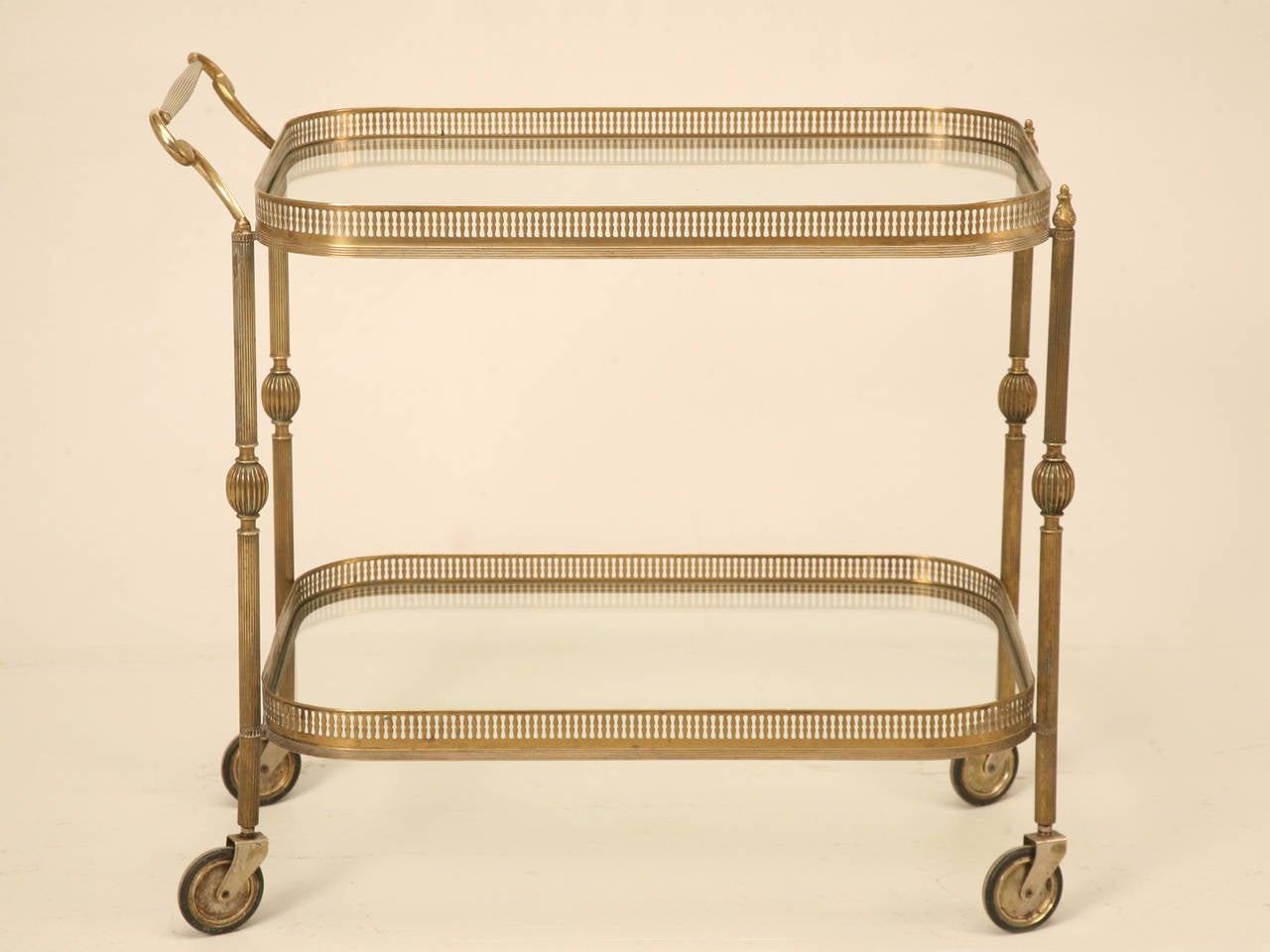 French vintage brass tea cart that has the look and weight of bronze, and if the seller had not told he thought it was brass, I would have sworn it was bronze. Either way, it has a lovely aged rich look without appearing to require a polishing,